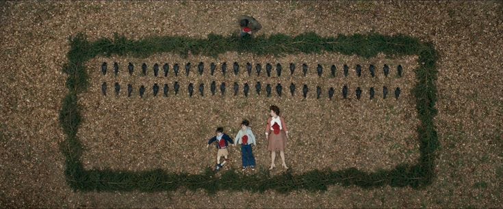 This may contain: three people standing in the middle of a field