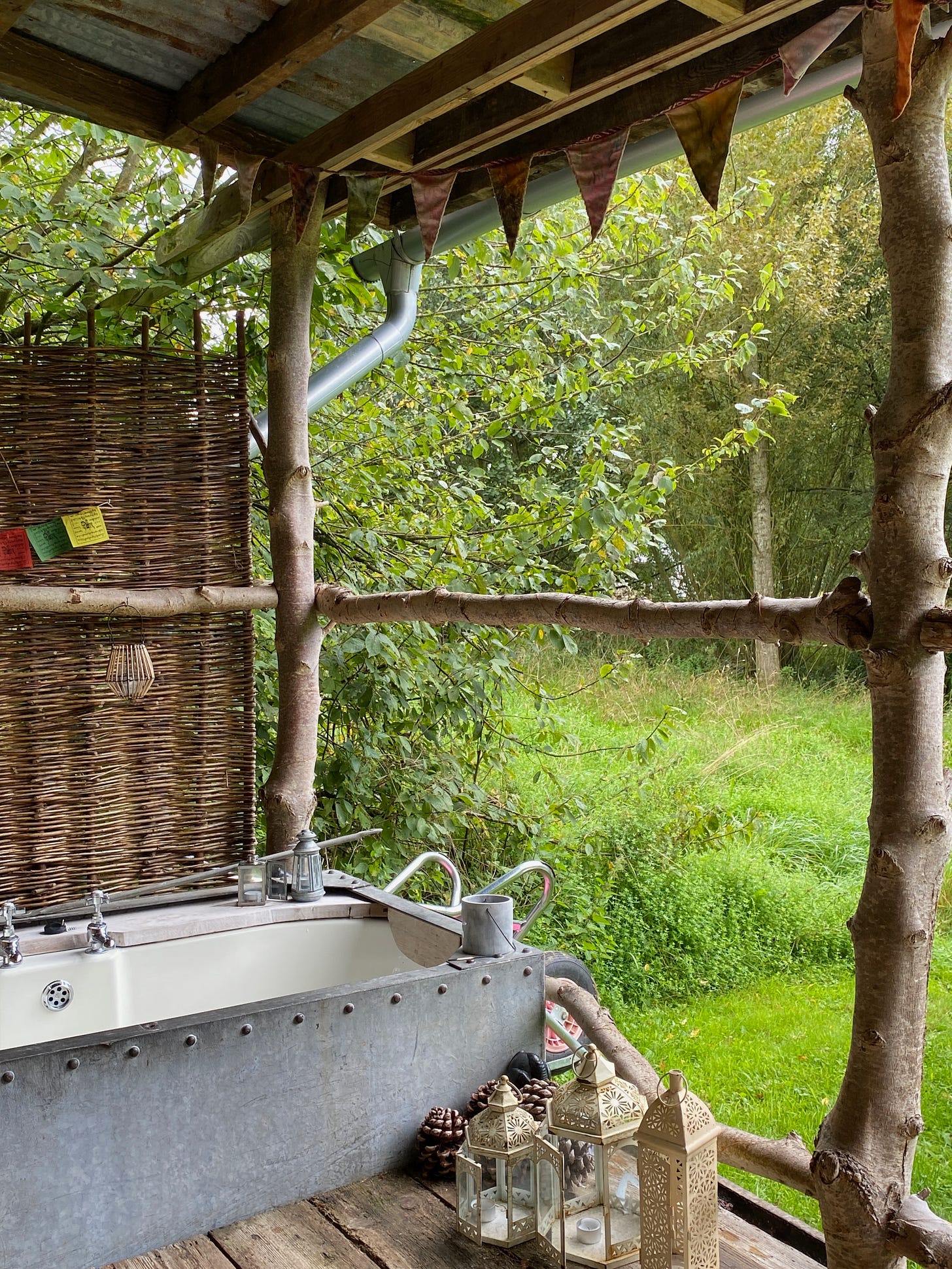 outdoor bath positioned on the veranda overlooking the meadow and lake