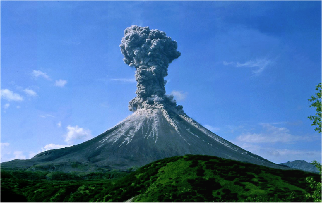 Mount Pinatubo eruption of 1991 sending ash into a clear, blue sky.