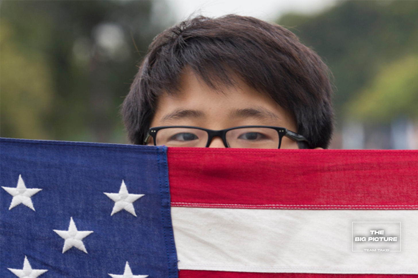 Asian American Boy Scout holds United States flag