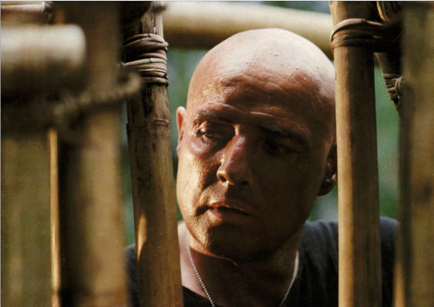 Kurtz (Marlon Brando) looking at bamboo bars