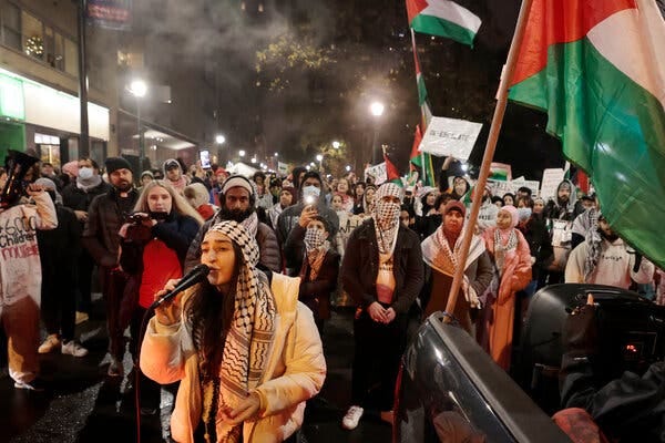 A group of protesters, some waving Palestinian flags, at a protest in Philadelphia.