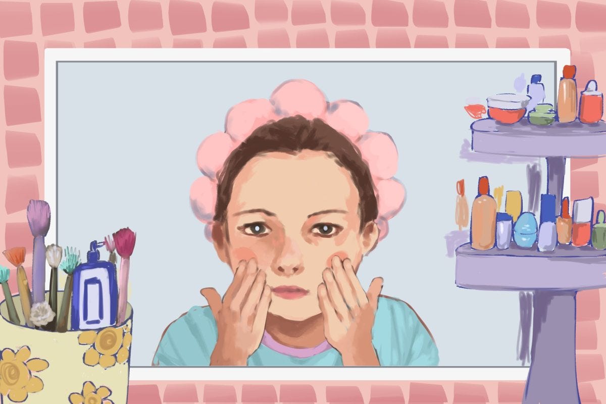 A preteen girl getting ready with a pink headband on, surrounded by makeup products.