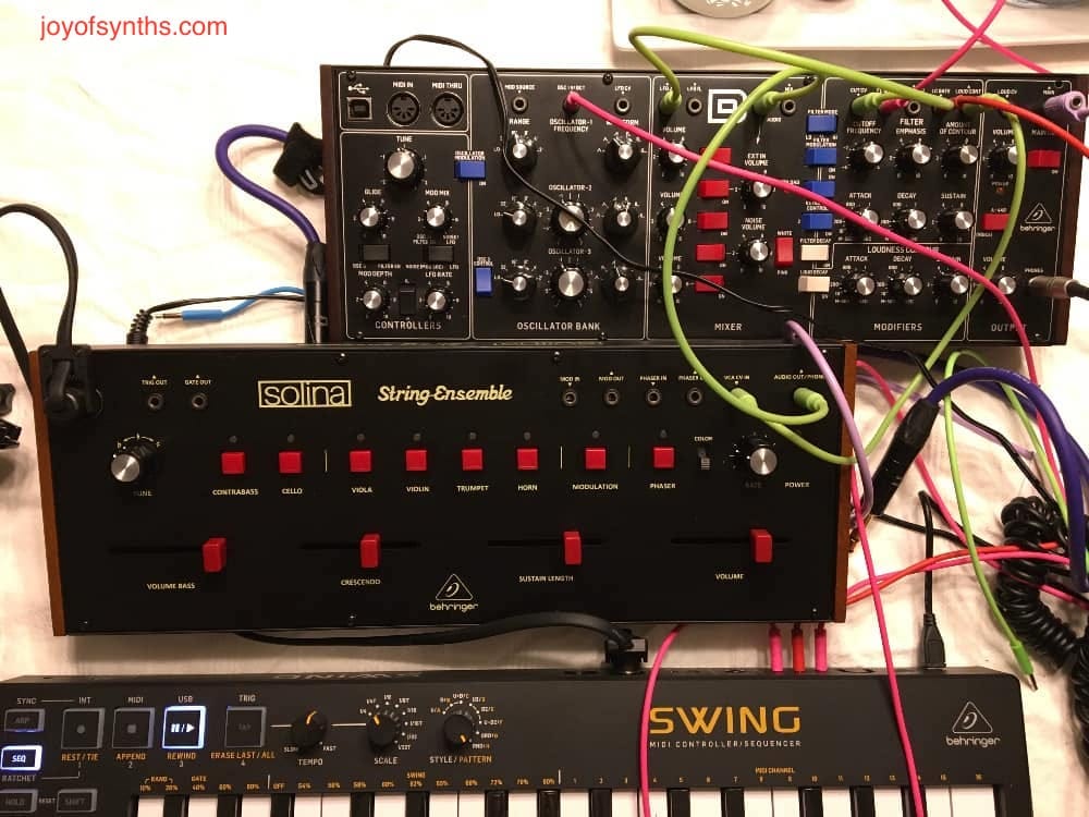 Two synthesizers connected with wires.