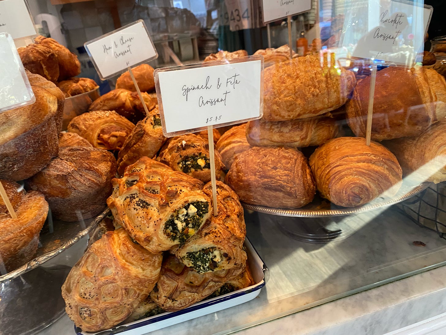 A glass case full of croissants.