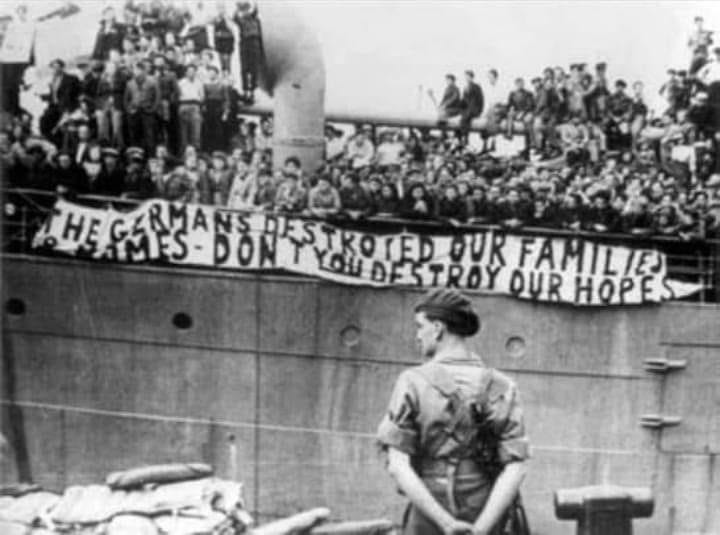r/Damnthatsinteresting - Jewish refugees entering Palestine in 1943 holding a banner saying "Germans destroyed our families and homes, don't you destroy our hopes."