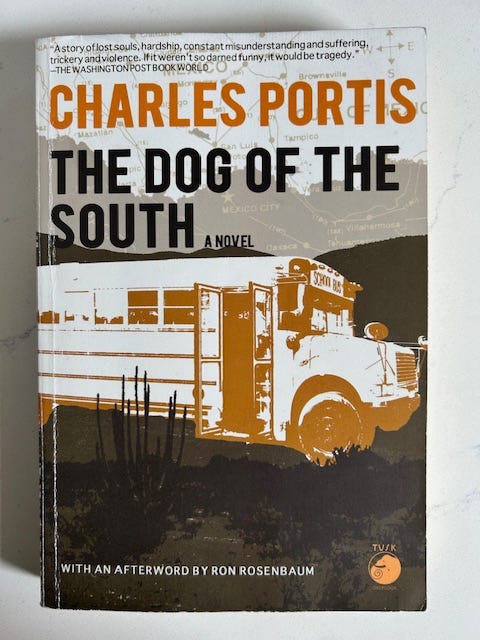 The cover of The Dog of the South by Charles Portis features a picture of a school bus. 