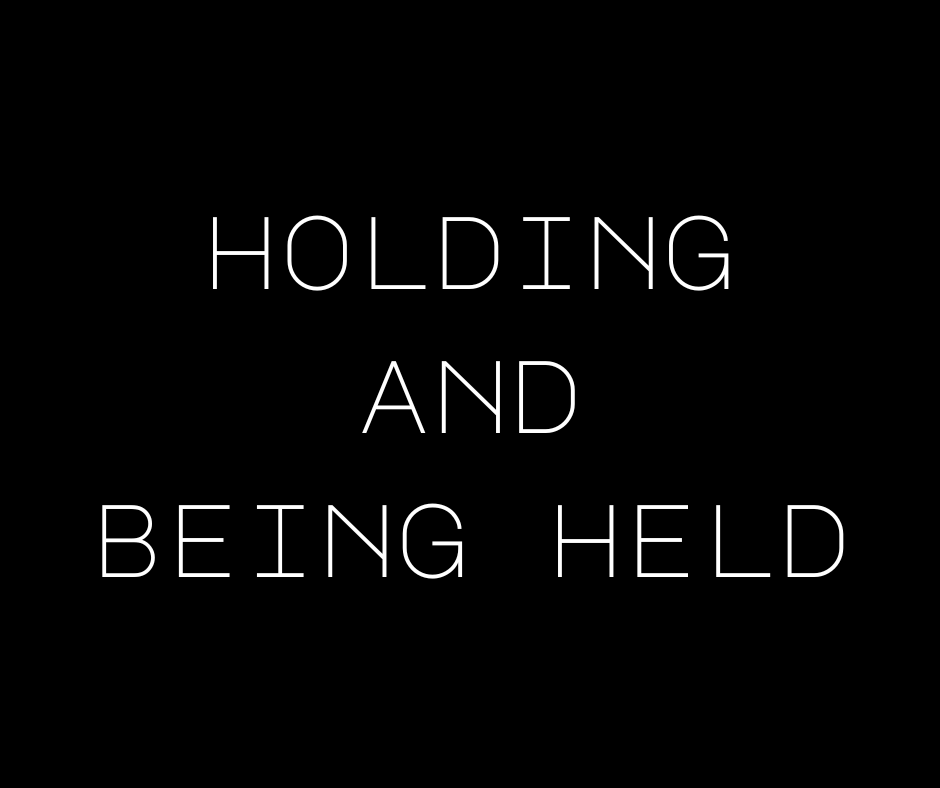 Text: Holding and being held.