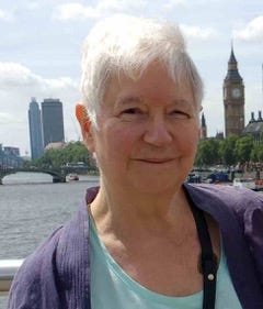 An 82 year old woman looking at the camera with Big Ben in the background