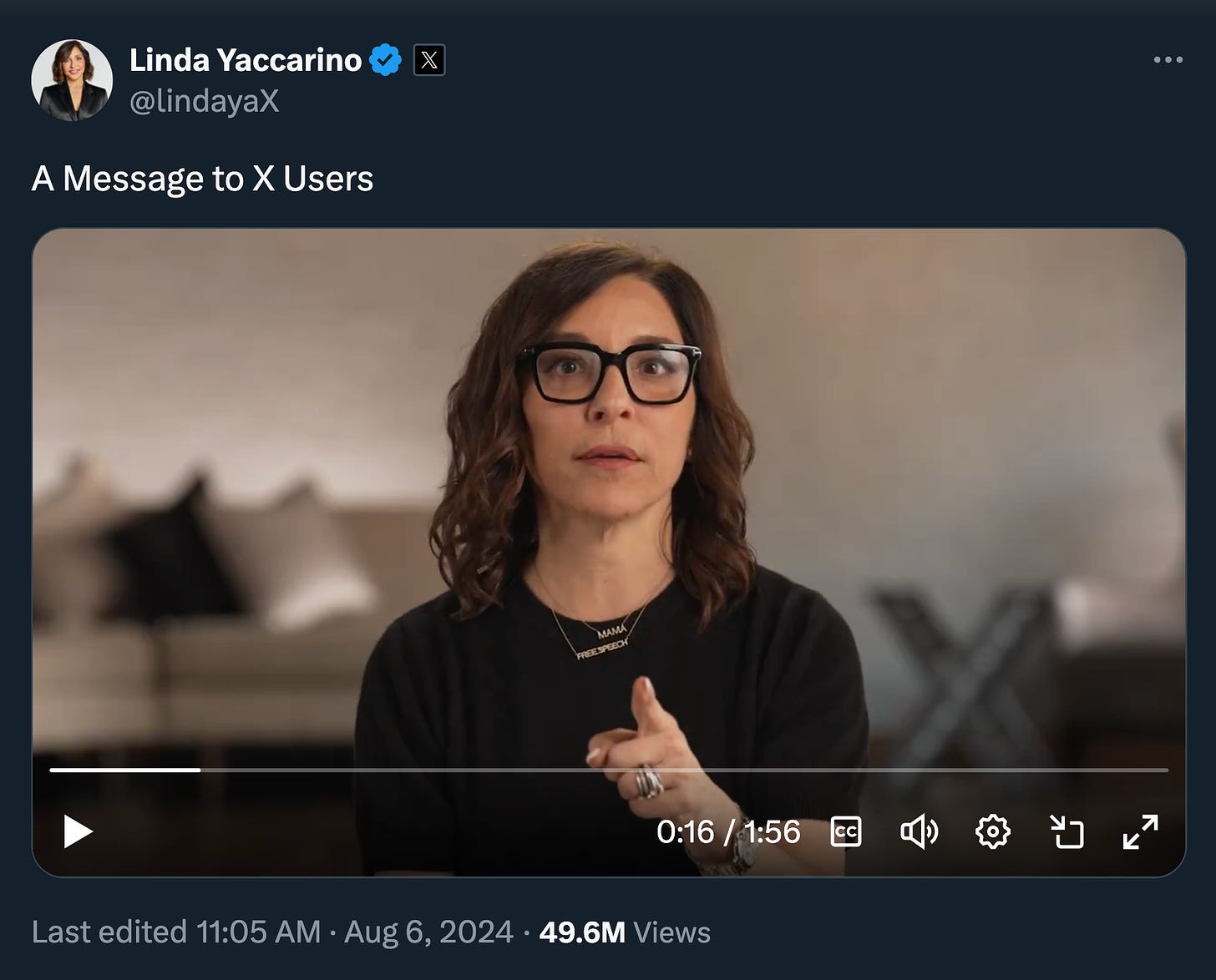 A tweet from Linda Yaccarino. Text: A Message to X Users. There's a video. She's wearing black glasses, a black shirt, a gold necklace that says "MAMA", and another that says "FREE SPEECH." She's pointing at the camera.