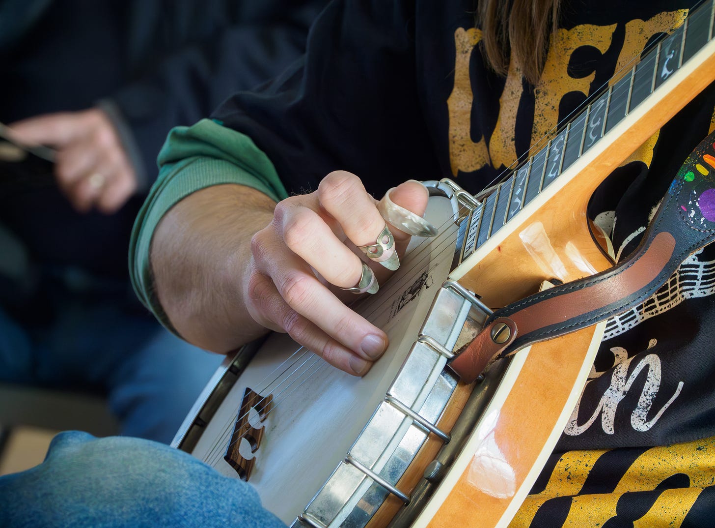 Man playing a five string banjo