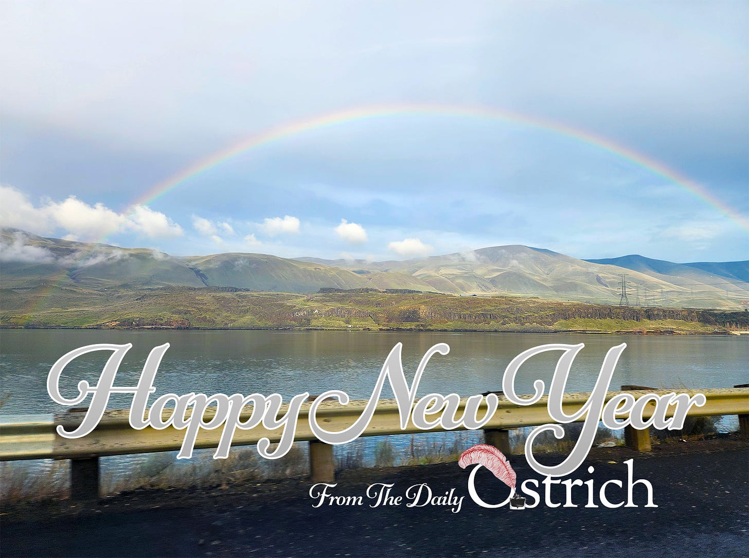 A rainbow over the Columbia, and text: Happy New Year from The Daily Ostrich