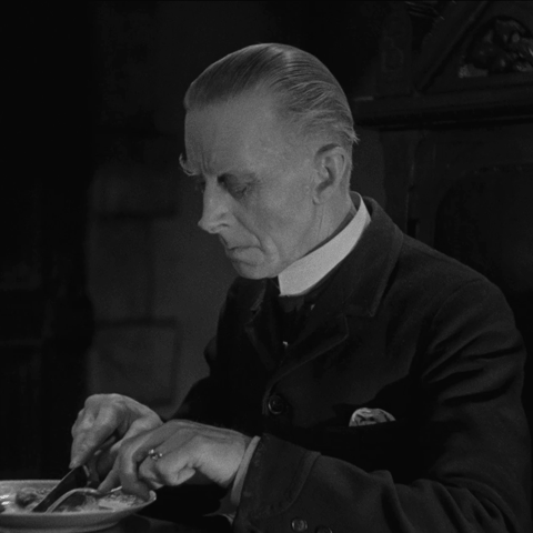 Animated gif - Ernest Thesiger as Horace Femm looks up from his dinner in 1932 film The Old Dark House