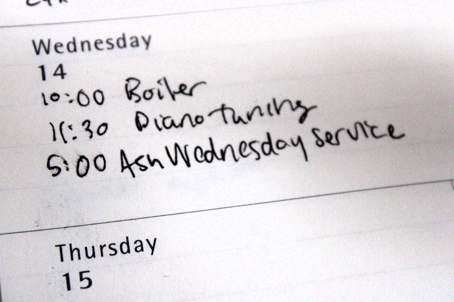A calendar page for Wednesday, February 14th that says 10:00 Boiler, 11:30 Piano Tuning, and 5:00 Ash Wednesday Service