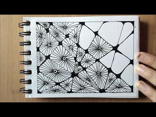 A repetitive black ink doodle on a white pad. It shows the same design in different sizes fit together using the Zentangle method.