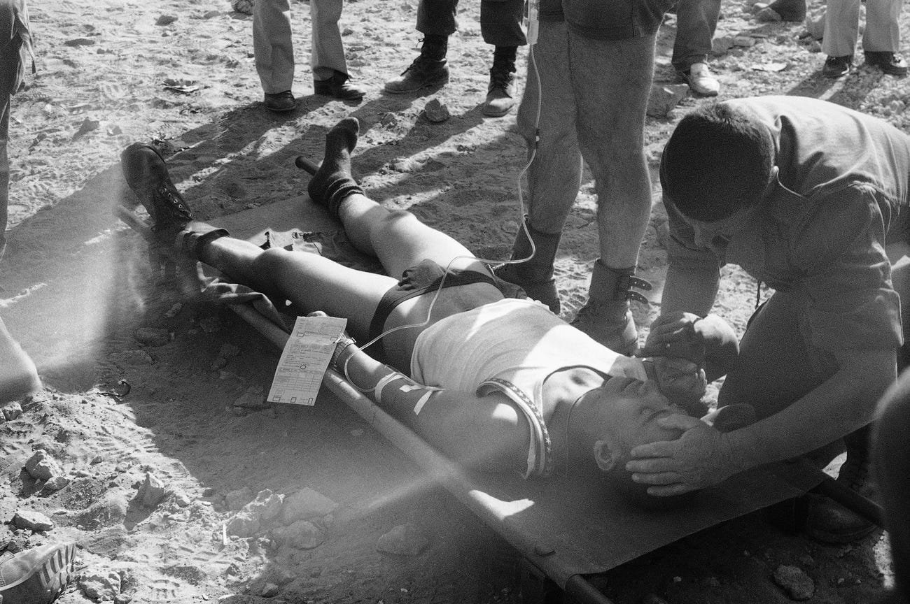 A wounded French soldier is attended to by a doctor after he was injured in a huge car bomb attack at a building housing members of the French contingent of the peacekeeping forces in Beirut.