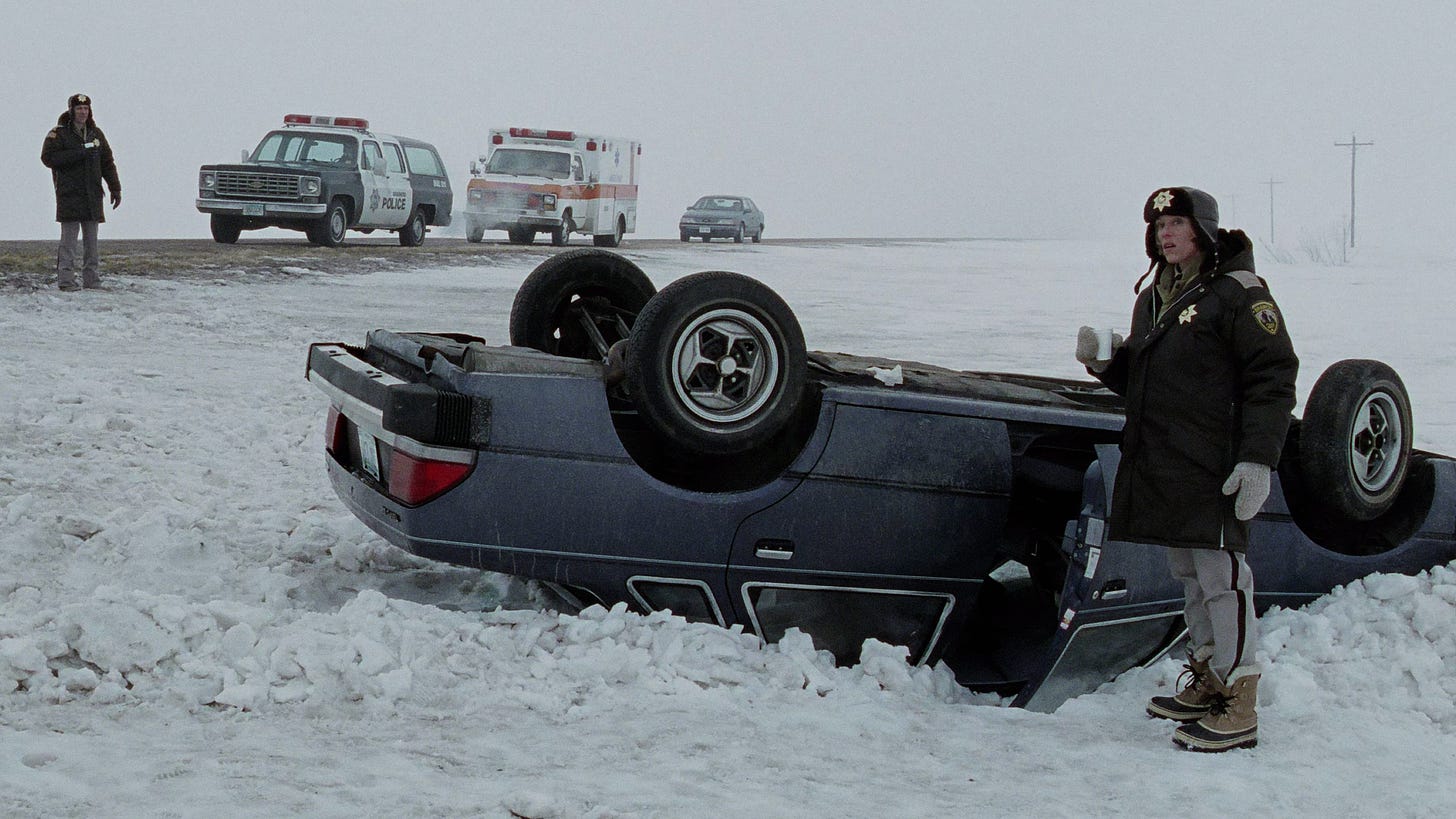 Fargo | Still features an overturned car in the snow. Marge Gunderson (Frances McDormand) watches over to see for anything suspicious.