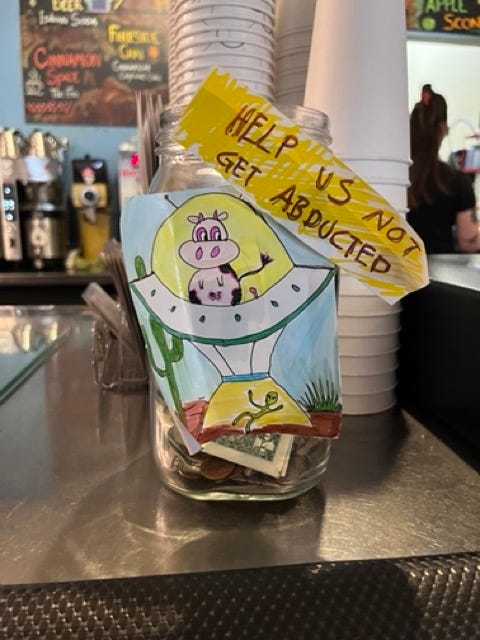 Sign on tip jar "Help us not get abducted"