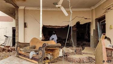 A man inspects damage as he walks through the rubble in a damaged room at a house that was hit by an artillery shell in the Azhari district in the south of Khartoum on June 6, 2023.