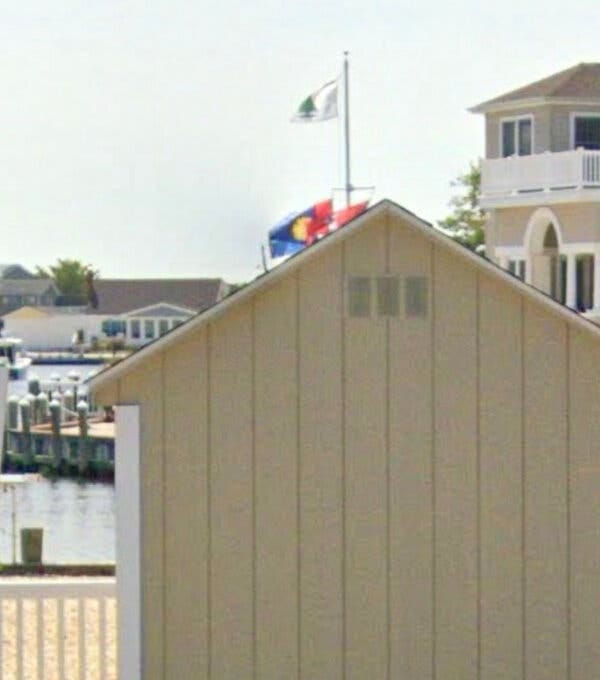 An “Appeal to Heaven” flag and other flags flying outside a beach house owned by Justice Samuel A. Alito Jr.