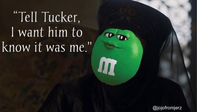 A green M&M looking smug, saying, "Tell Tucker, I want him to know it was me."