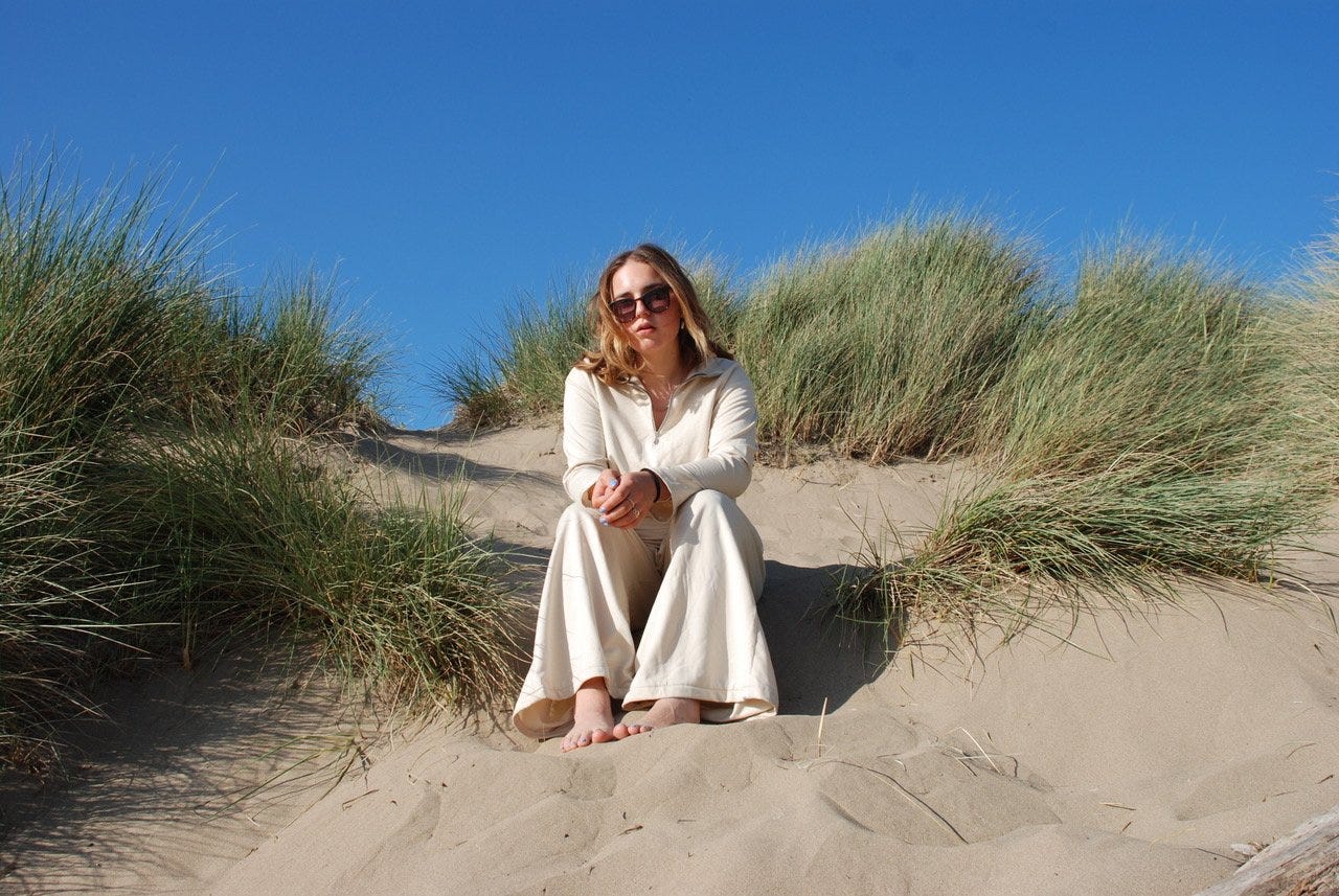 Model on a beach in Beatriss Bayliss clothes