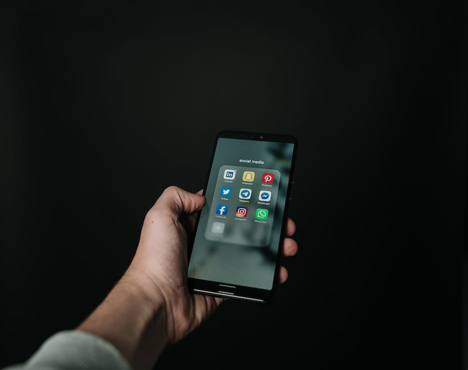 Free Photo of Hand Holding a Black Smartphone Stock Photo