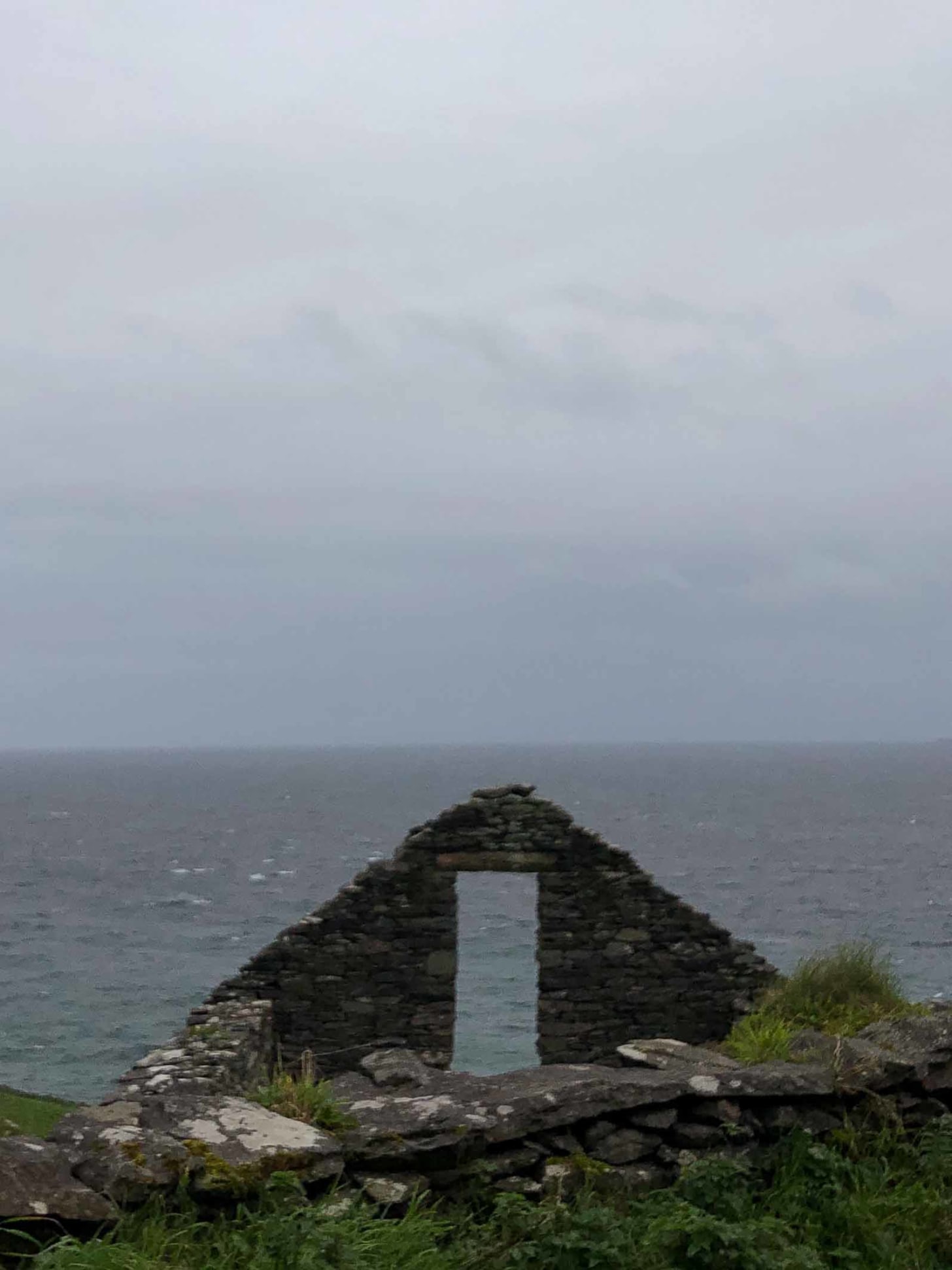 The ruin of a window looks out onto the sea in the west coast of Ireland. Photo credit: Nancy Forde. All rights reserved. nancyforde.com