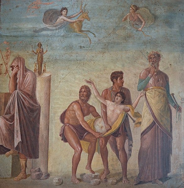 photograph of a wall painting showing the sacrifice of ipihgenia including a nube girl in the arms of three male figures, a woman with her head covered, and a partial image of Artemis with a deer in the sky