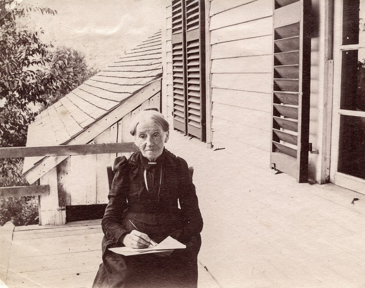 Woman writing while seated on deck