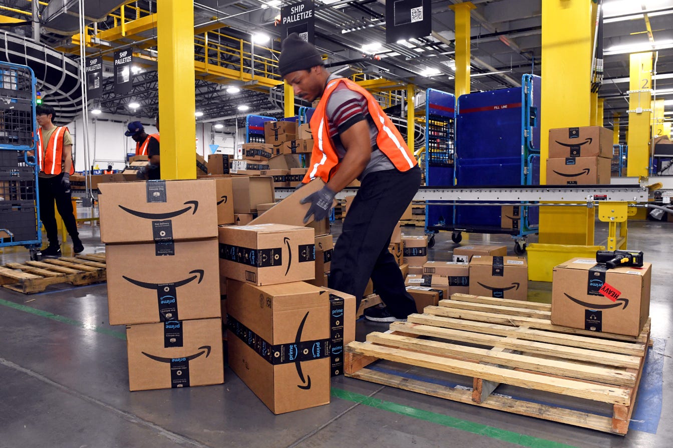 Amazon worker handling packages at a warehouse