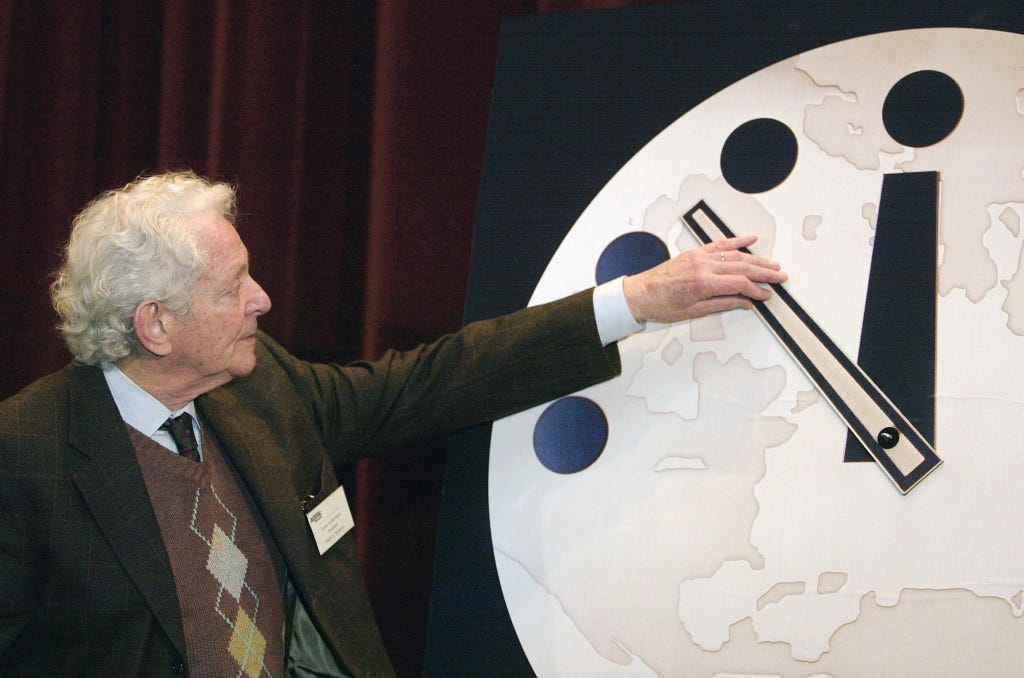 Physics Nobel Prize winner Leon M. Lederman adjusting the hands of the Doomsday Clock at the University of Chicago