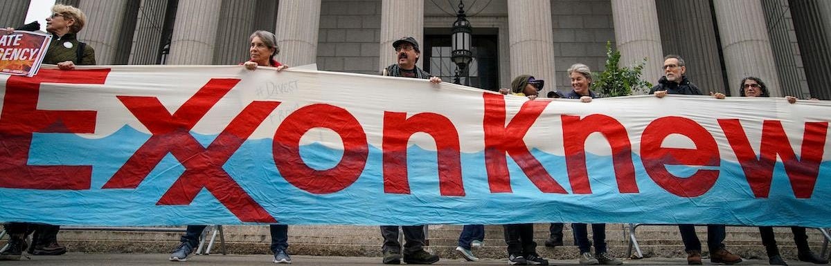 Protesters hold "Exxon knew" banner