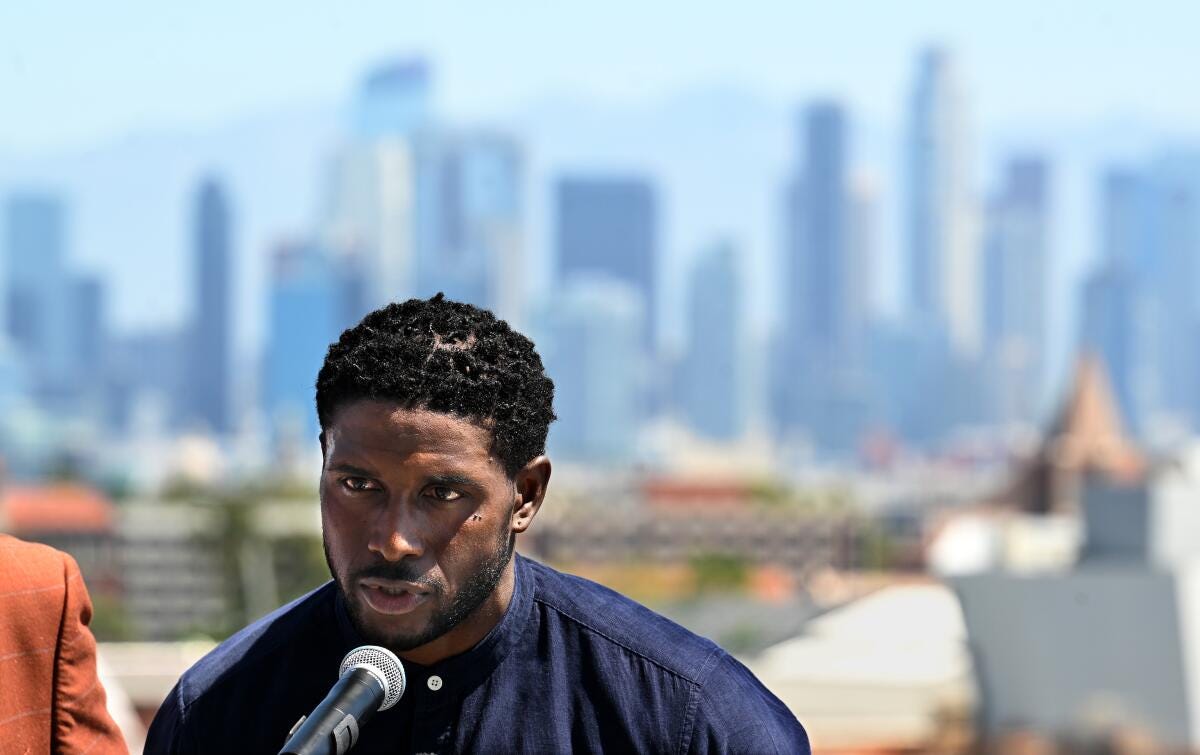Former USC running back Reggie Bush lobbied to get his Heisman Trophy during a news conference at the Coliseum.