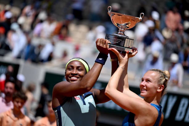 Coco Gauff of United States and Katerina Siniakova of Czechia celebrate with the trophy after victory against Jasmine Paolini of Italy and Sara...