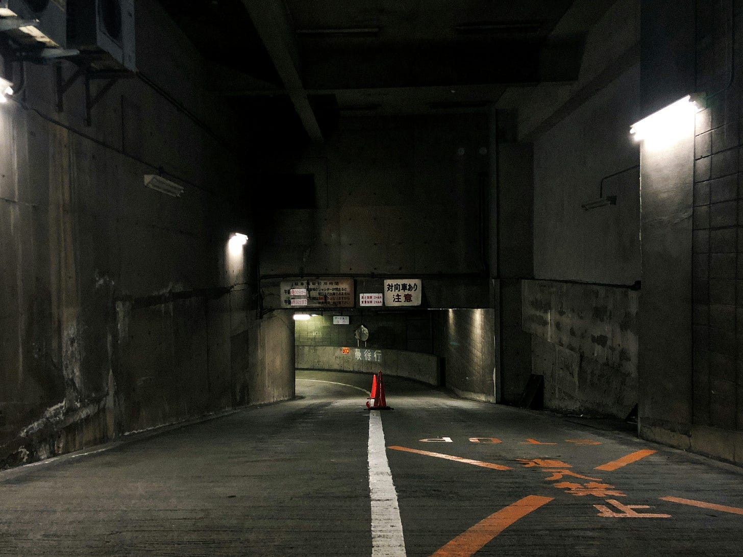 Dark descending parking garage ramp