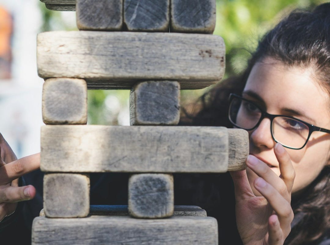 woman playing with wooden blocks