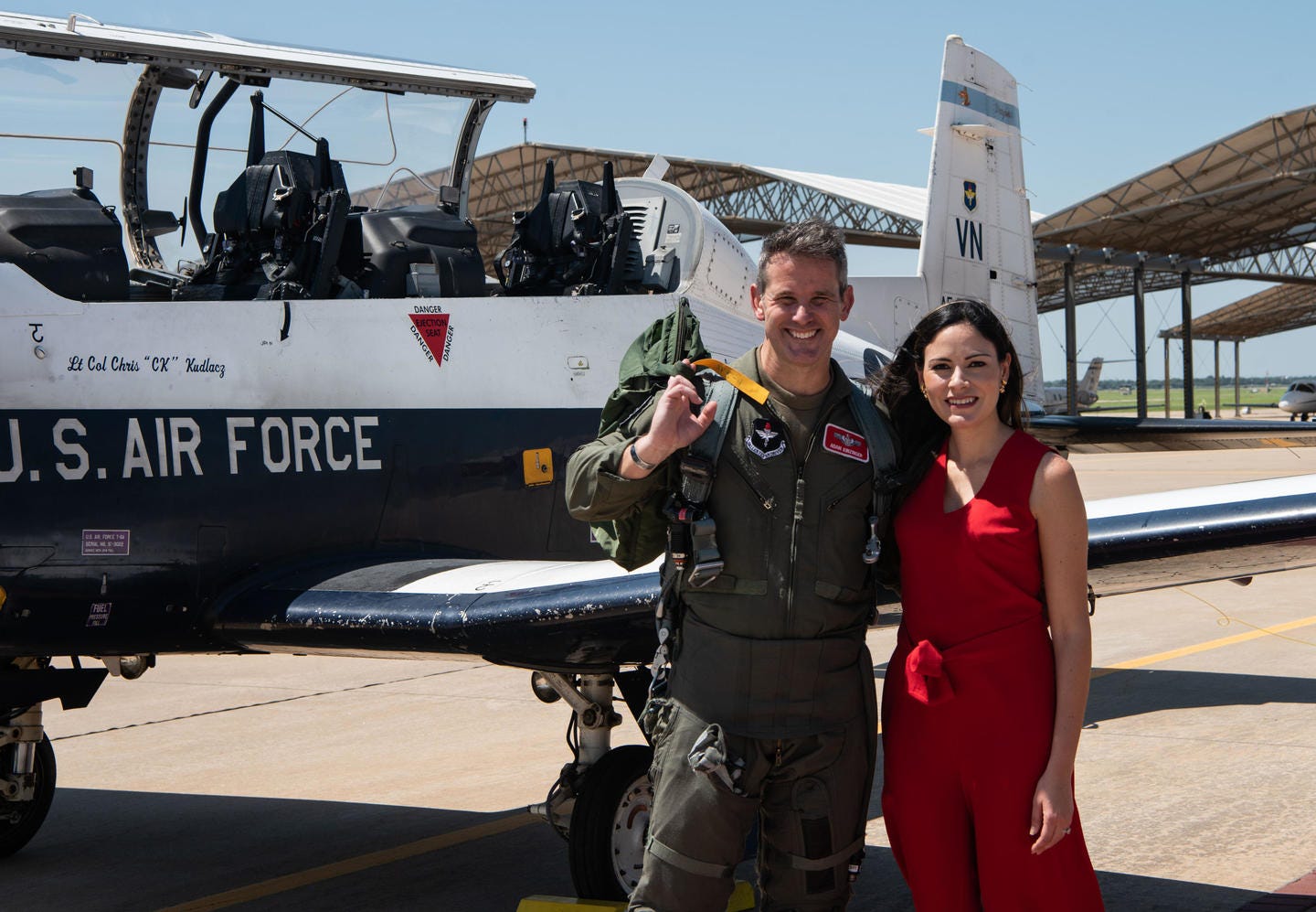 The Honorable Adam Kinzinger, the Congressman for the 16th District of Illinois and a lieutenant colonel in the Wisconsin National Guard, stands with his wife Sofia in front of a T-6A Texan II, July 9, 2021, at Vance AFB, Okla.