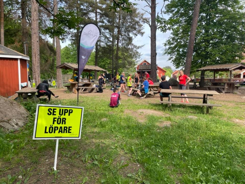 An open-air area with picnic benches and the parkrun flag.