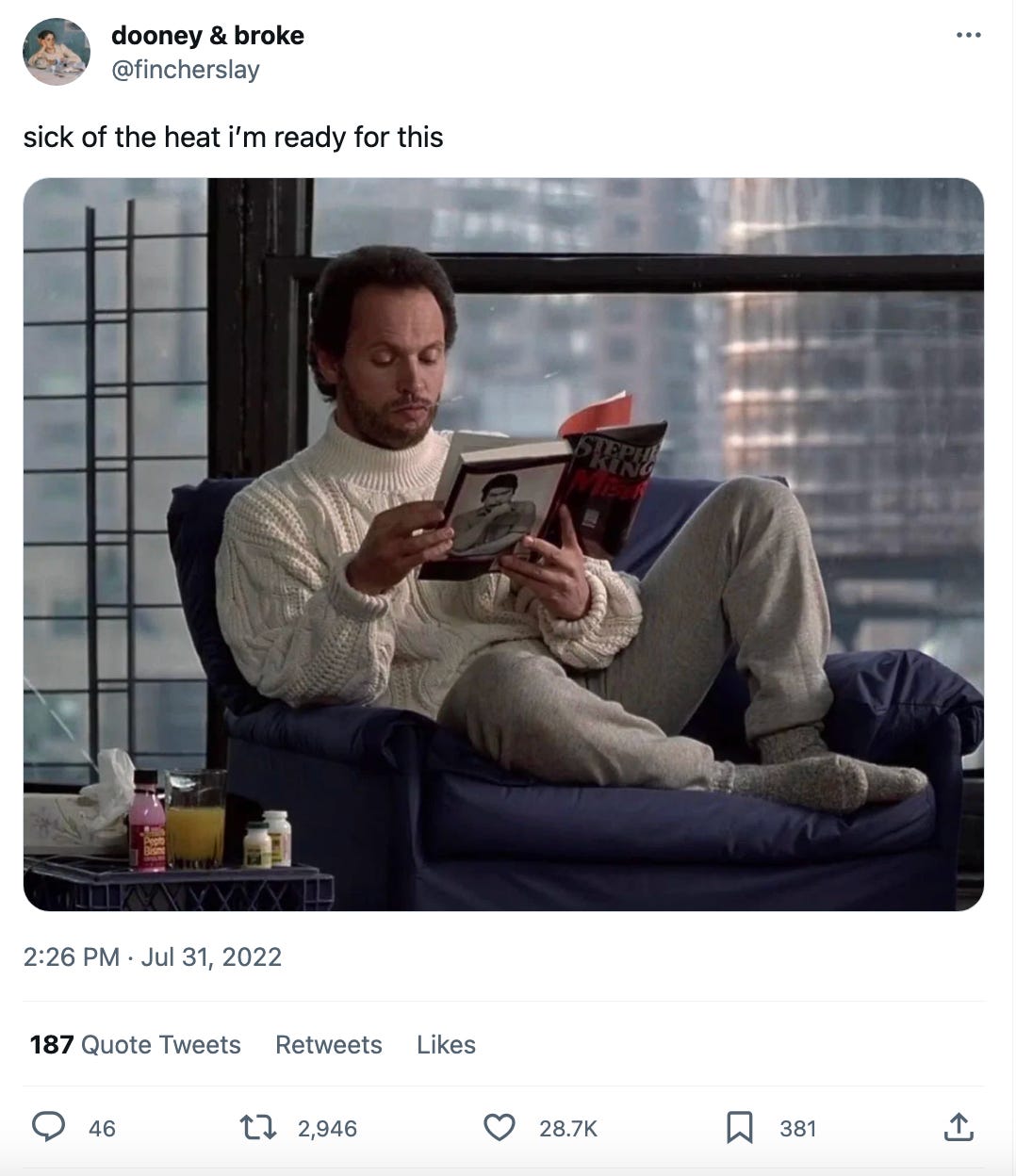 A tweet from @fincherslay that reads, "sick of the heat i'm ready for this." And it's a photo of Billy Crystal in WHEN HARRY MET SALLY reading a Stephen King novel in a white Aran sweater.