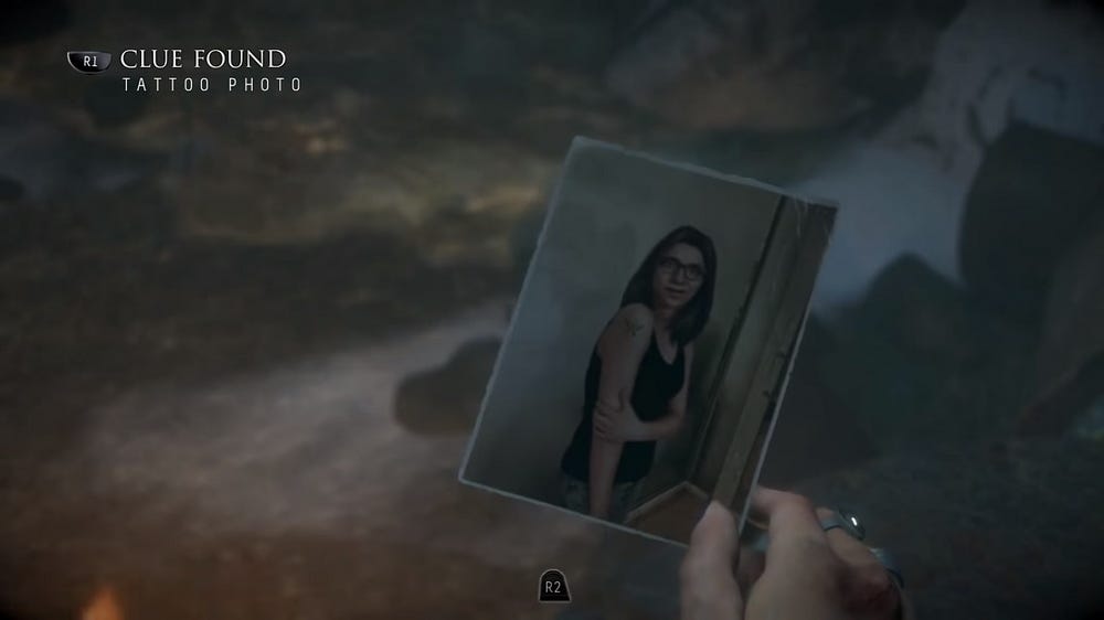 A screenshot from Until Dawn saying CLUE FOUND: Tattoo Photo. We see a photo of Hannah when she was alive, sporting a butterfly tattoo on her arm.