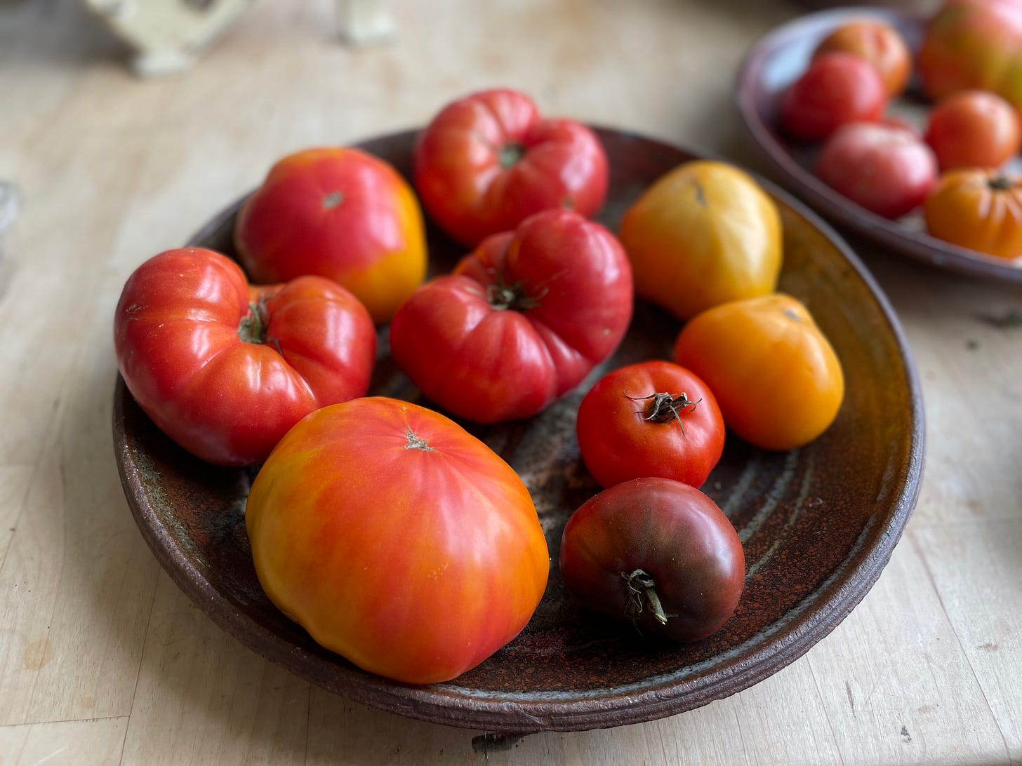 Gorgeous red, yellow and orange heirloom tomatoes on a platter