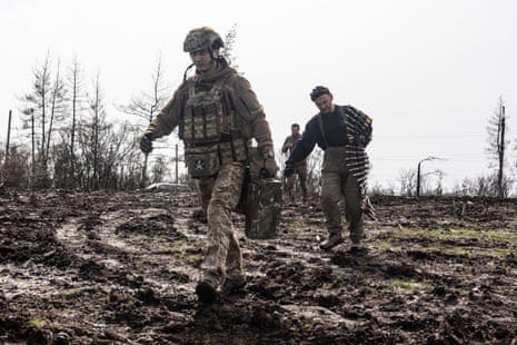 Ukrainian soldiers carry ammunition for a BMP.