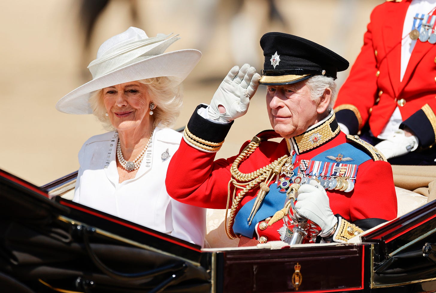 King Charles and Queen Camilla in a carriage 