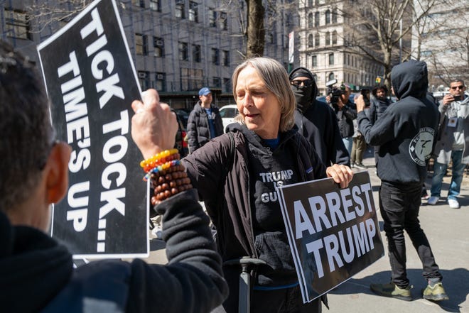 People gather outside a Manhattan courthouse as the nation waits for the possibility of an indictment against former President Donald Trump by the Manhattan District Attorney Alvin Bragg's office on Tuesday in New York City.