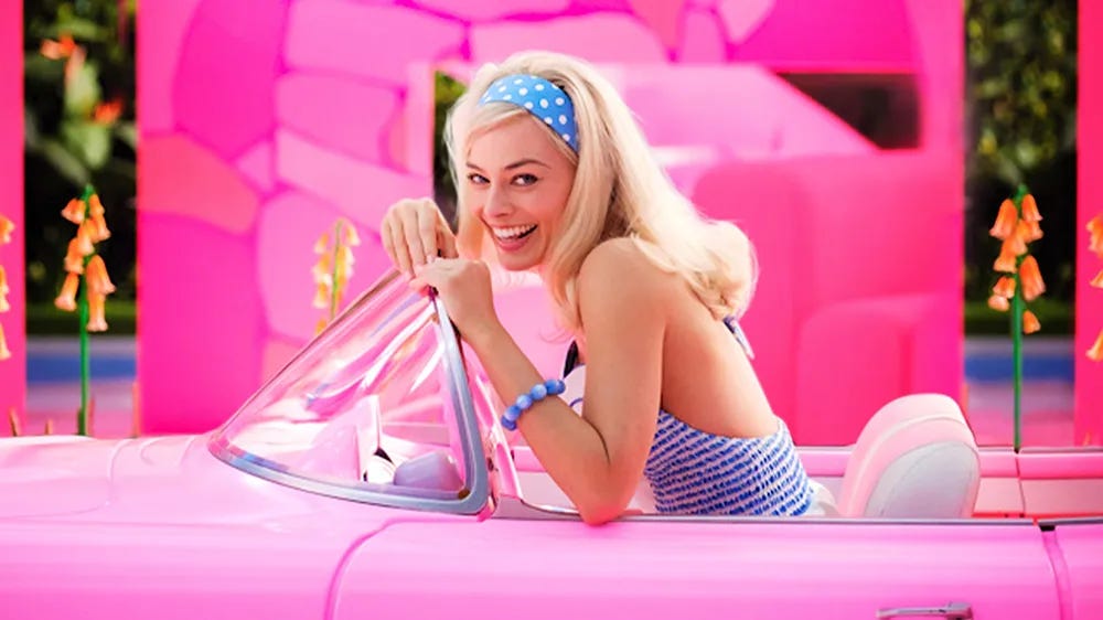 Barbie Driver. (Margot Robbie as Barbie driving a car.)