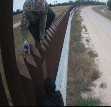 Migrant climbing Border Wall in Texas