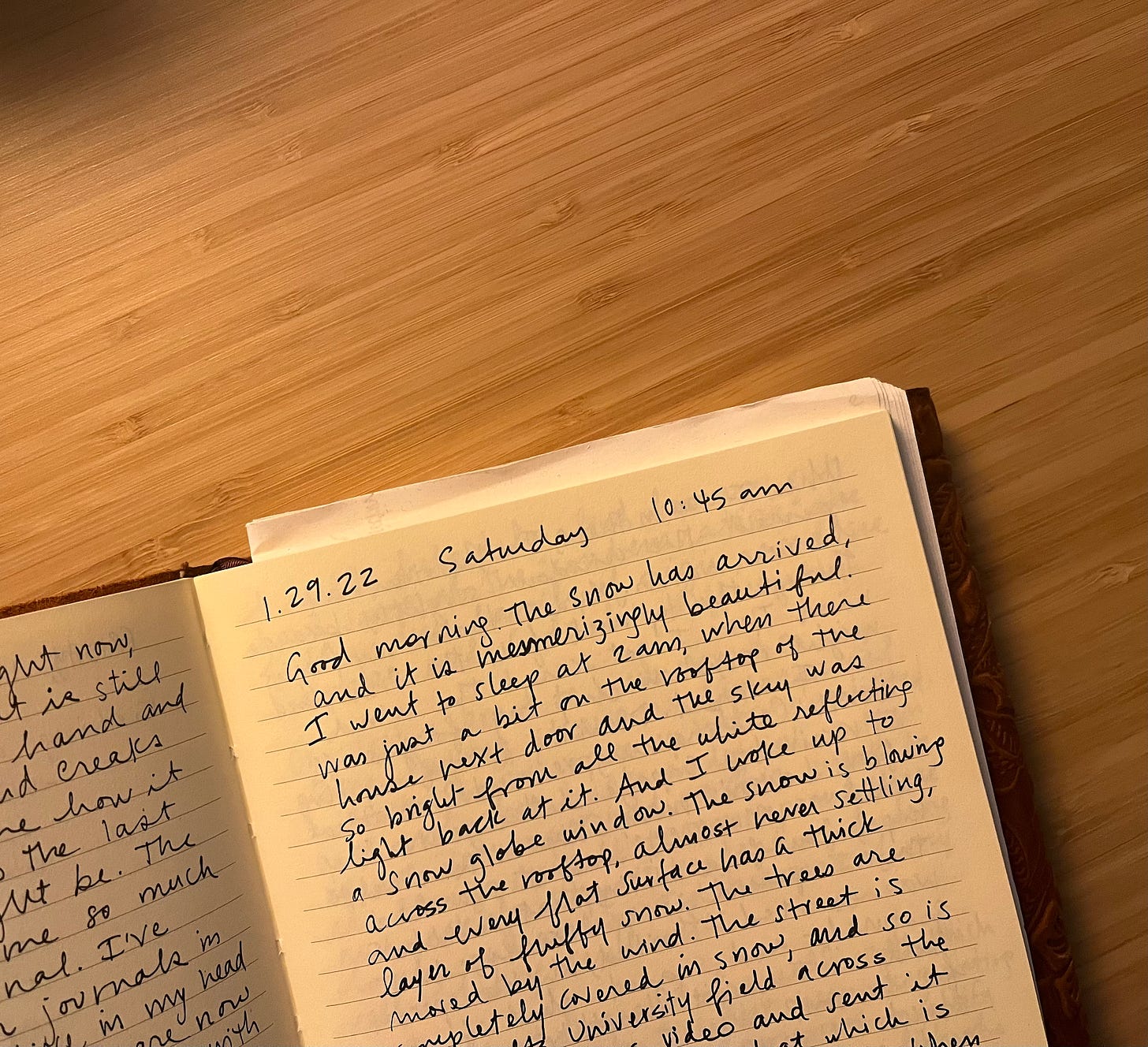 A photo of the corner of Isa's open diary, on a wooden table. On the right page, part of an entry is visible, from January 29, 2022. It was written that Saturday at 10:45 am. 