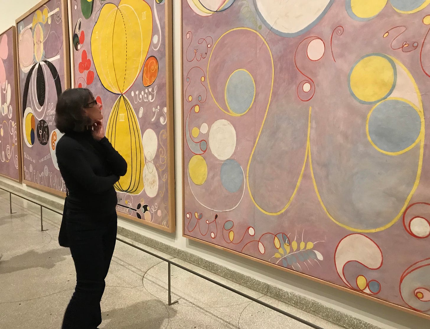 the author standing in a gallery and looking at one of the paintings known as the Ten Largest by Hilma af Klint
