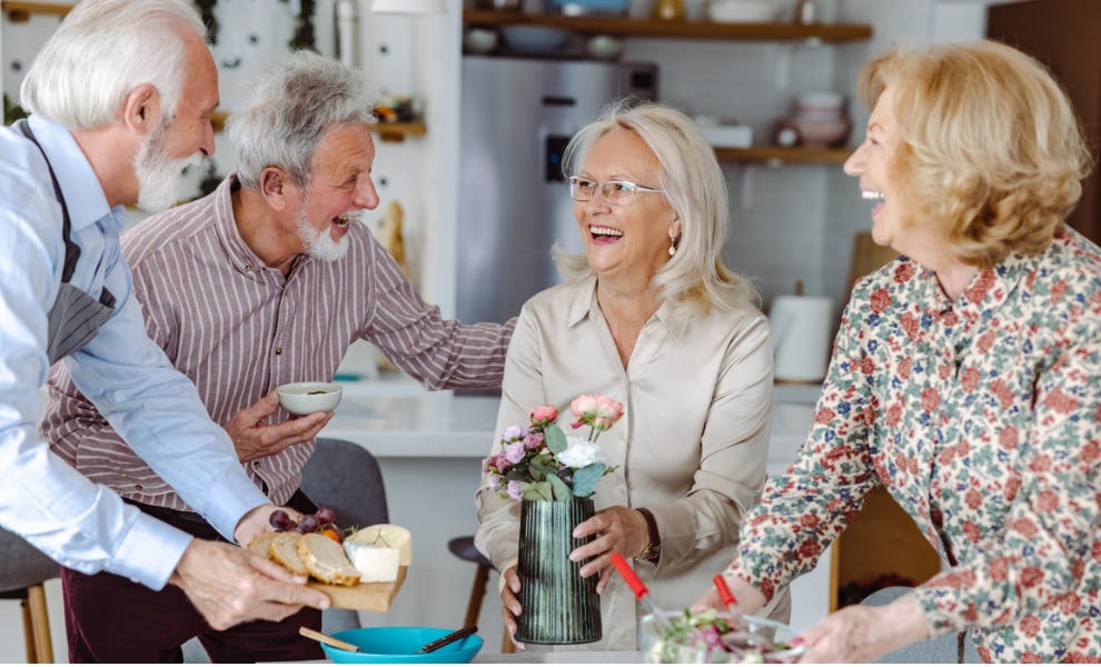 Group of older people enjoying a meal together